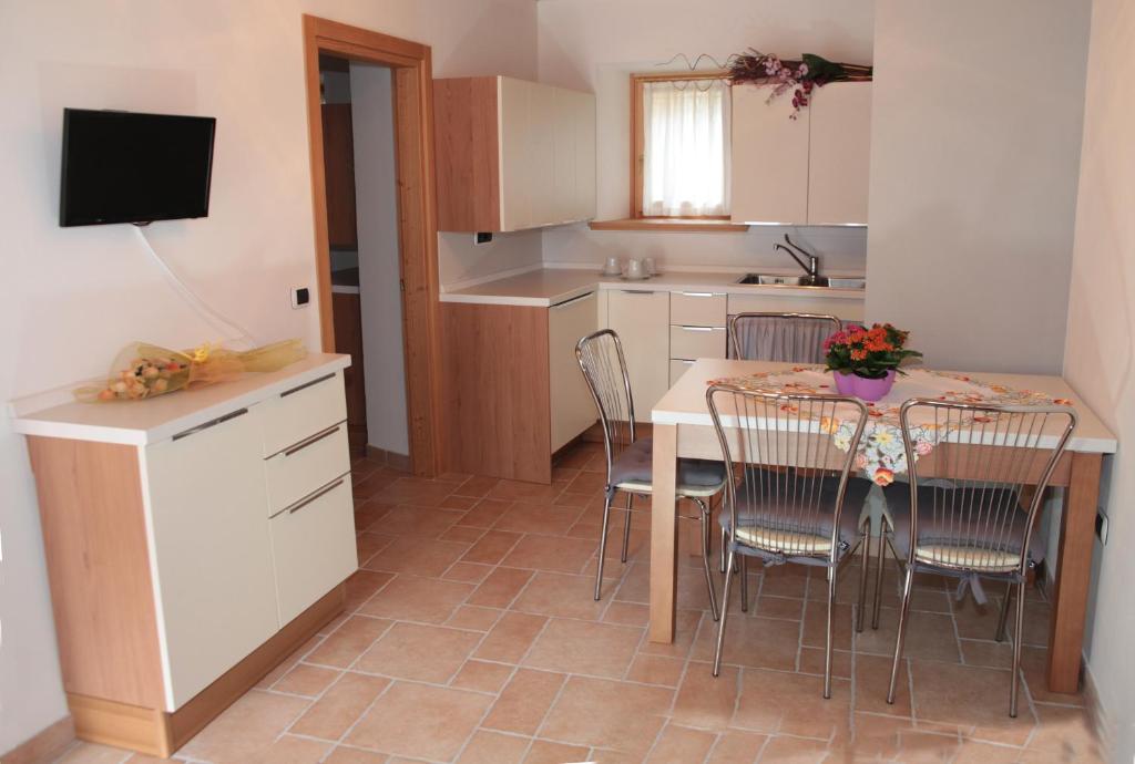 a kitchen with a table and chairs in a kitchen at Albergo diffuso Valcellina e Val Vajont in Claut in Claut