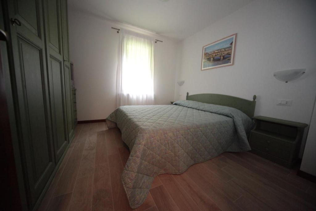 a bedroom with a bed in front of a window at Albergo diffuso Valcellina e Val Vajont in Claut in Claut