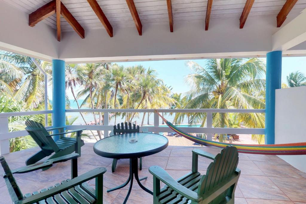 a hammock on a porch with chairs and a table at Condo #22 @ Beachside Villas in Seine Bight Village