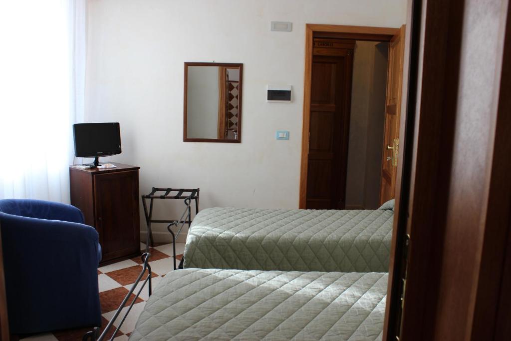 sypialnia z łóżkiem, lustrem i krzesłem w obiekcie Villa Cosilinum w mieście Padula
