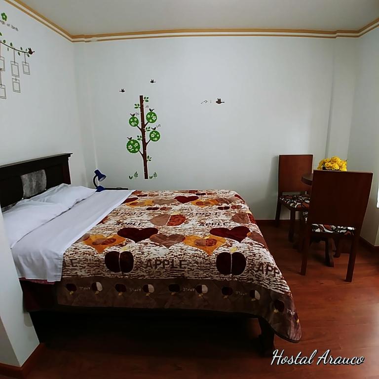 Postel nebo postele na pokoji v ubytování Hostal Arauco