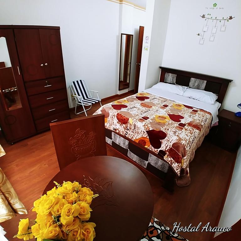 Postel nebo postele na pokoji v ubytování Hostal Arauco