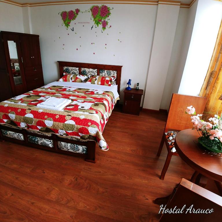 Postel nebo postele na pokoji v ubytování Hostal Arauco