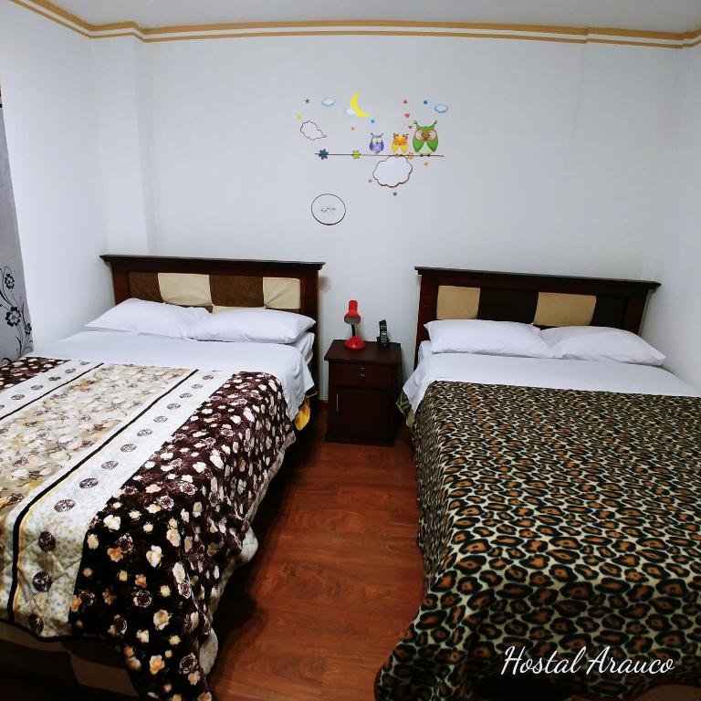 Postel nebo postele na pokoji v ubytování Hostal Arauco