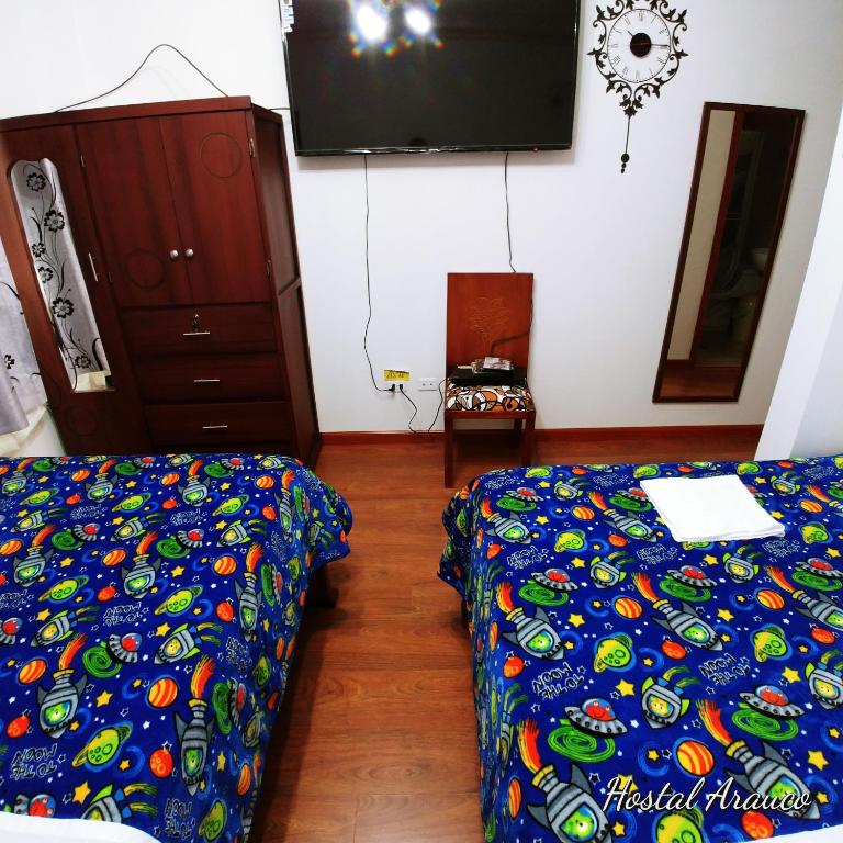 Postel nebo postele na pokoji v ubytování Hostal Arauco