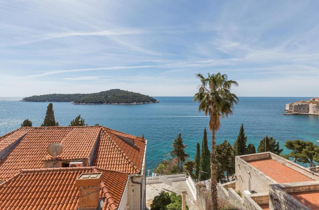 a view of the ocean from the roofs of buildings at Apartment View in Dubrovnik