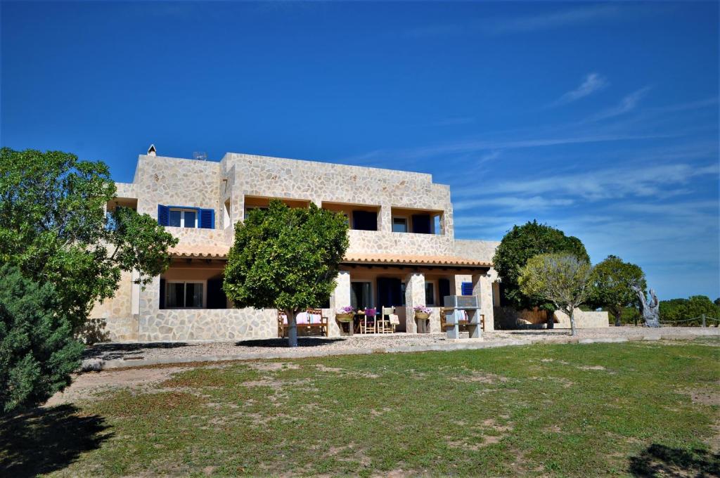 a large stone house with trees in front of it at Siamoformentera Donatella in San Ferrán de ses Roques