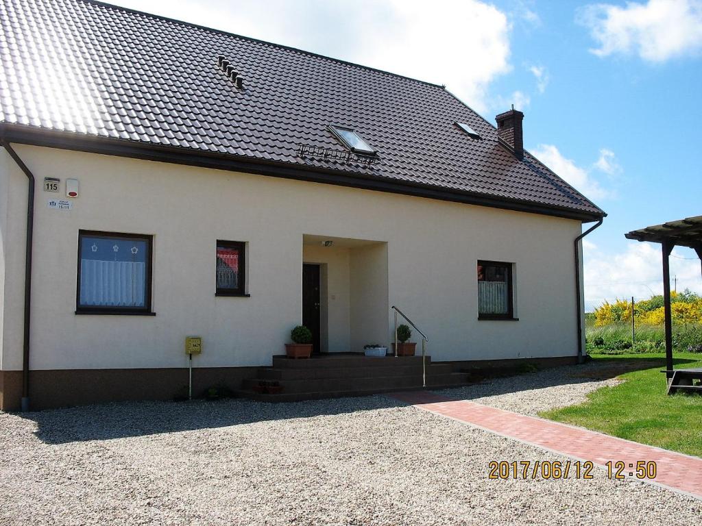 a white house with a black roof at Willa Marzenie in Władysławowo