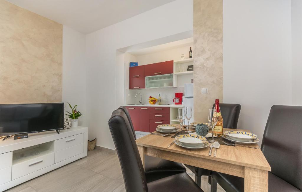 a dining room with a table with chairs and a television at Villa Stephany in Poreč