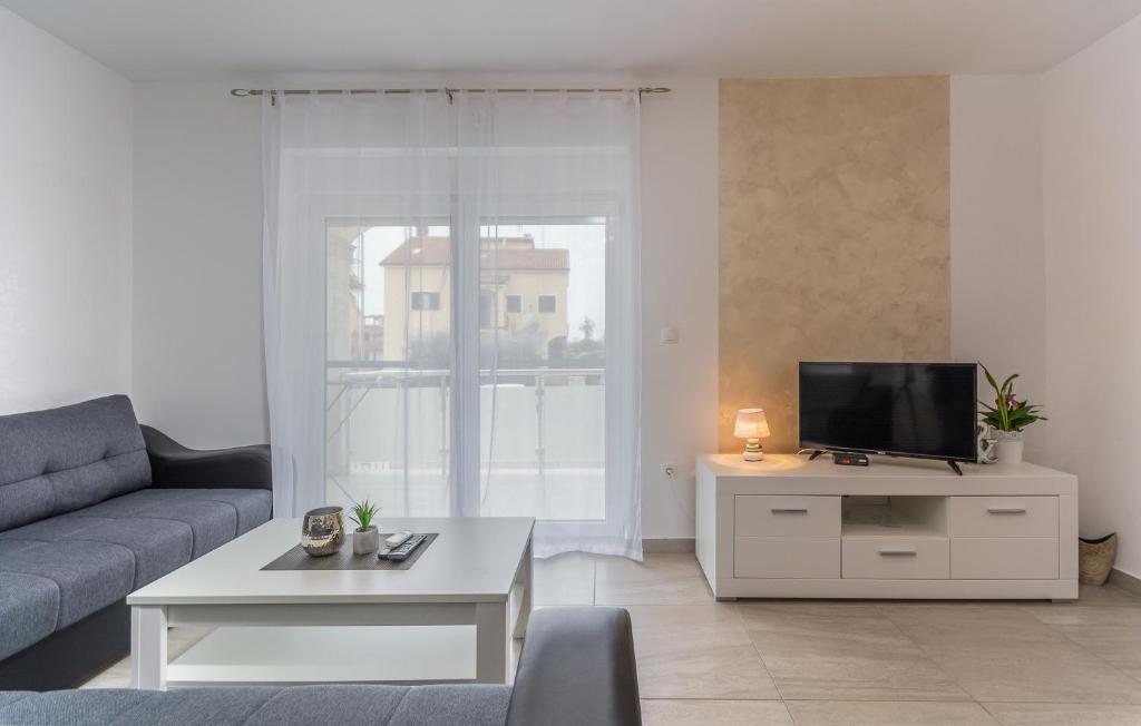 a living room with a couch and a tv at Villa Stephany in Poreč