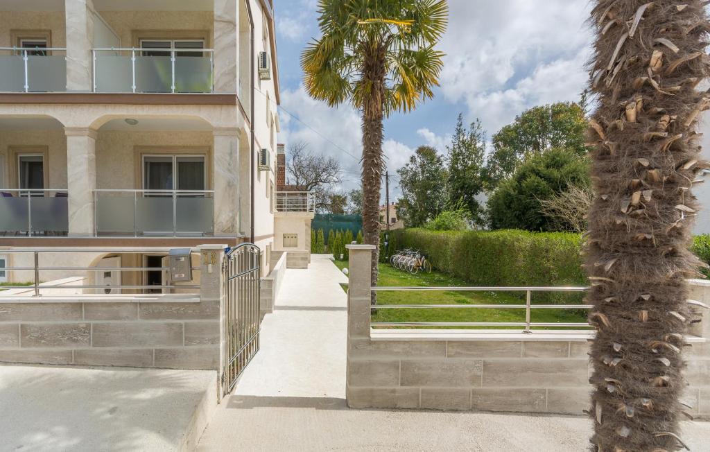 a palm tree in front of a building at Villa Stephany in Poreč