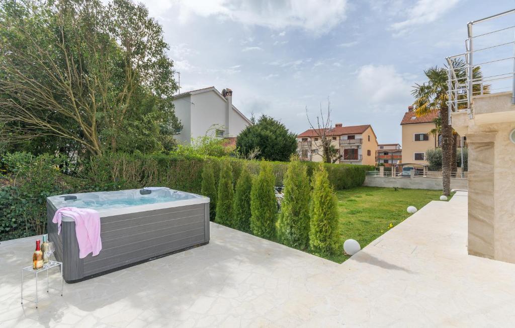 a hot tub on a patio in a yard at Villa Stephany in Poreč