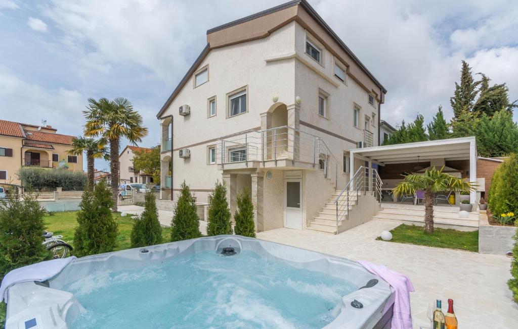 a villa with a swimming pool and a house at Villa Stephany in Poreč