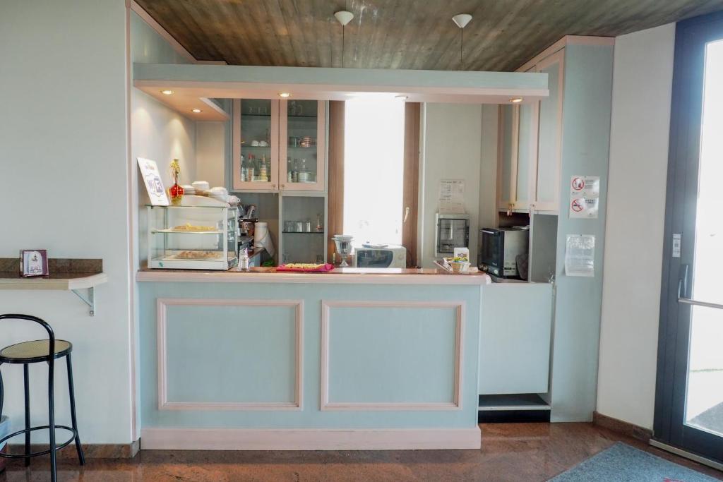 a kitchen with white cabinets and a counter top at L'incanto Di Boccadarno in Marina di Pisa