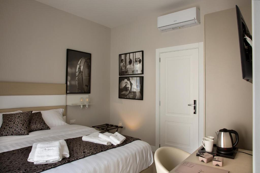 A bed or beds in a room at Naplesuite