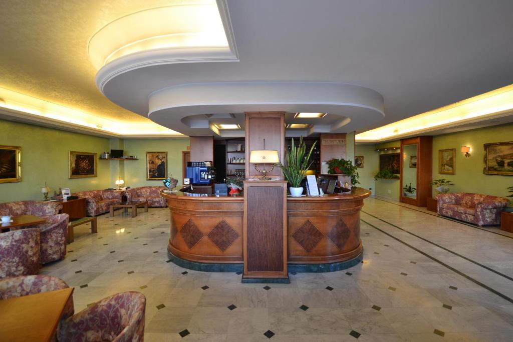 a hotel lobby with a bar in the middle at Sun Hotel in Rubiera