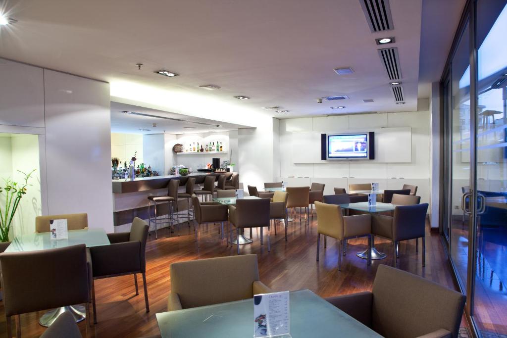 a restaurant with tables and chairs and a bar at Divan Istanbul City in Istanbul