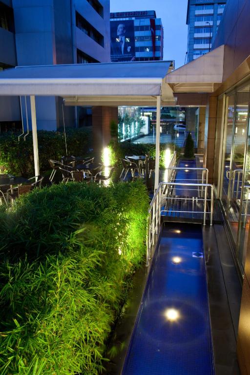 a pool in the middle of a building at night at Divan Istanbul City in Istanbul