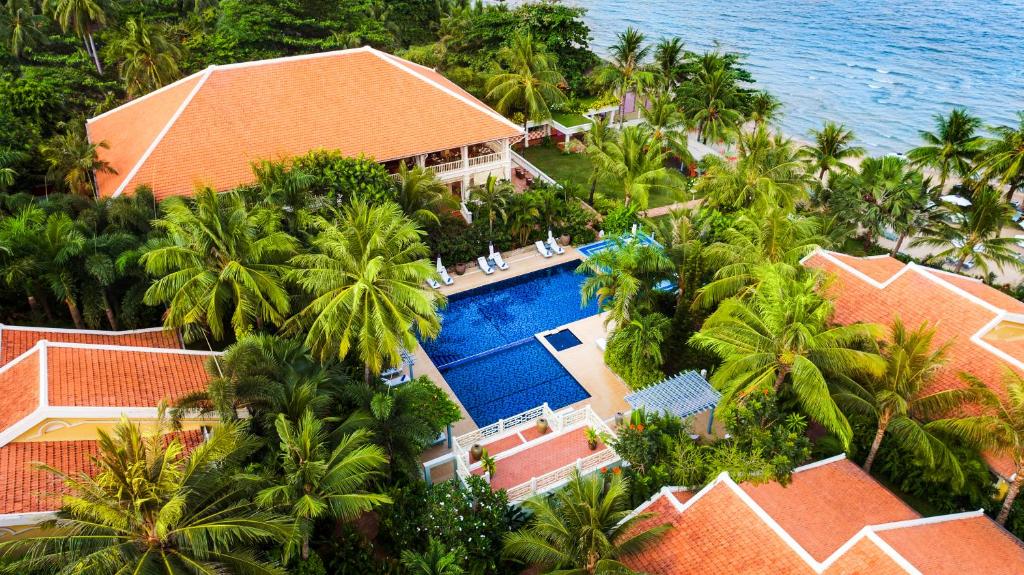 
a beach with palm trees and palm trees at La Veranda Resort Phu Quoc - MGallery in Phú Quốc
