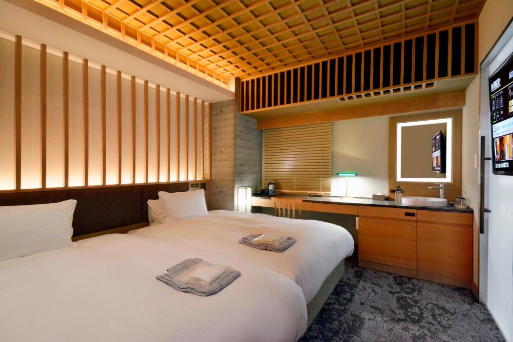 Postel nebo postele na pokoji v ubytování HOTEL HILLARYS Akasaka