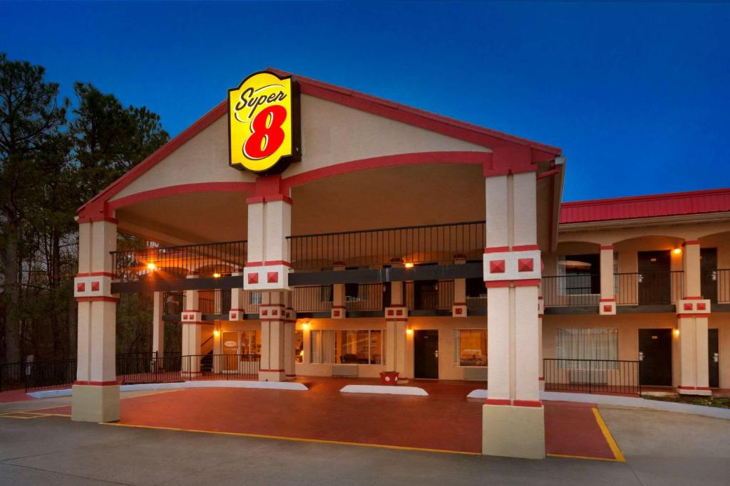 a gas station with a sign on the front of it at Super 8 by Wyndham College Park/Atlanta Airport West in Atlanta