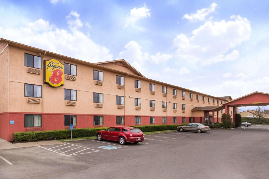 a hotel with a car parked in a parking lot at Super 8 by Wyndham Corvallis in Corvallis