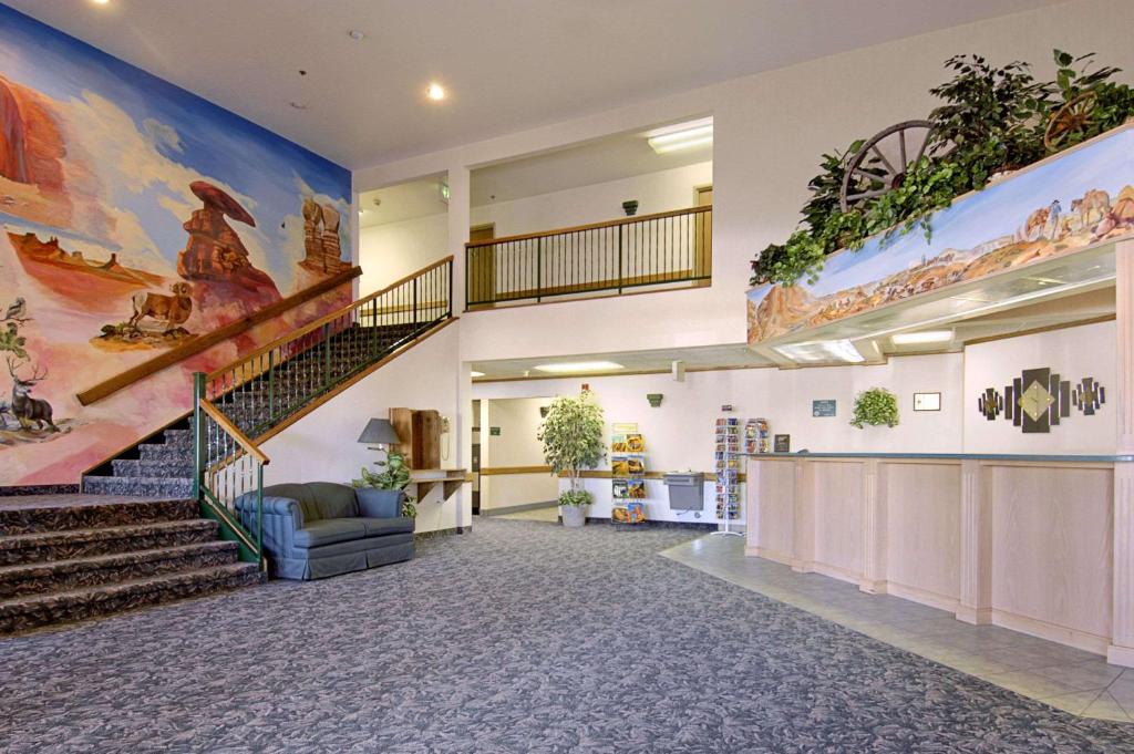a large lobby with stairs and a staircase at Arch Canyon Inn in Blanding