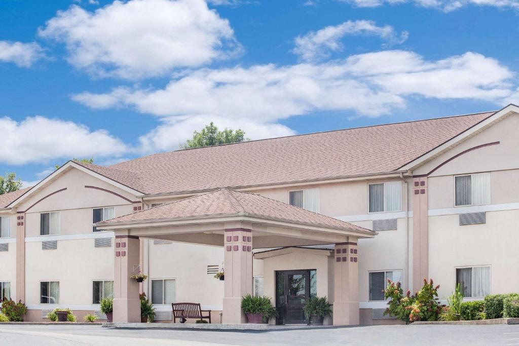 a large white building with a roof at Super 8 by Wyndham Central City in Central City