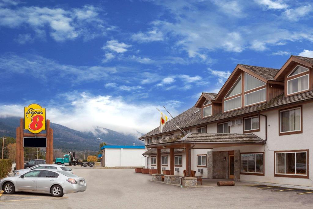 a car parked in a parking lot in front of a motel at Super 8 by Wyndham Valemount in Valemount