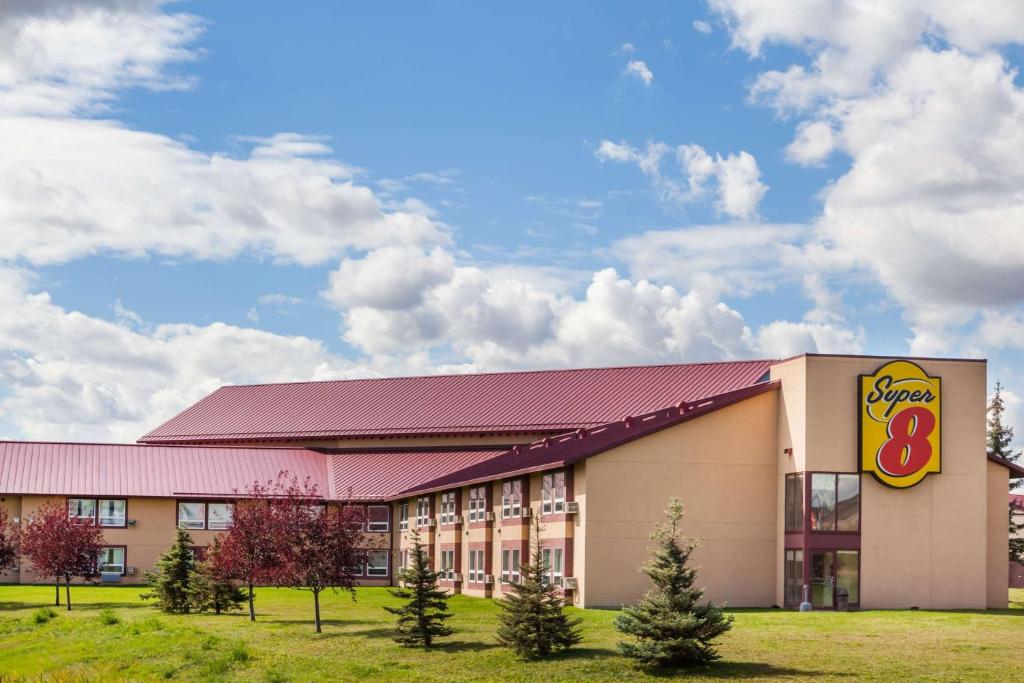 a building with a krispy kreme sign on it at Super 8 by Wyndham Sherwood Park/Edmonton Area in Sherwood Park