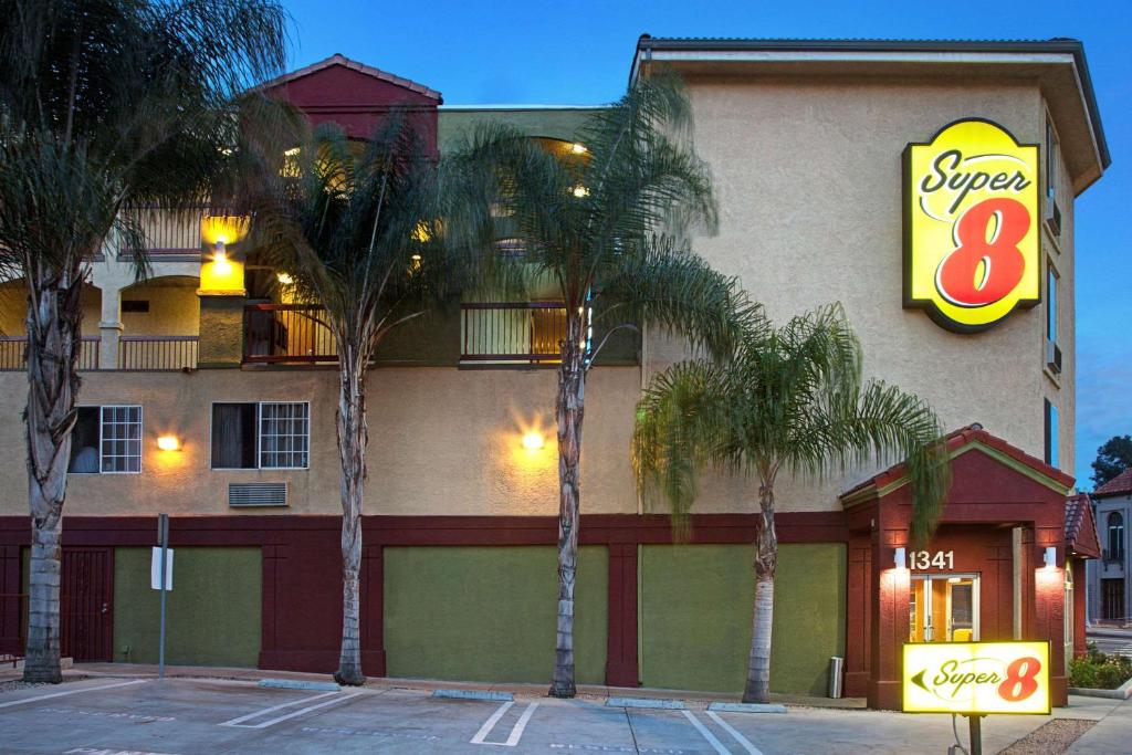 a building with palm trees in front of it at Super 8 by Wyndham Los Angeles Downtown in Los Angeles