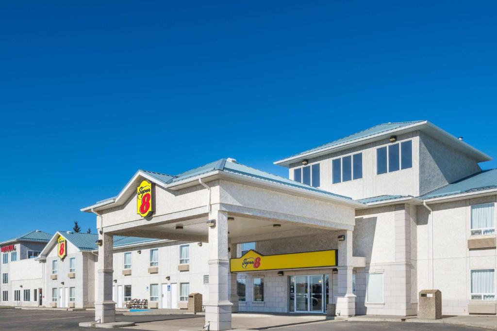 a hotel exterior with a gas station at Super 8 by Wyndham Vermilion AB in Vermilion