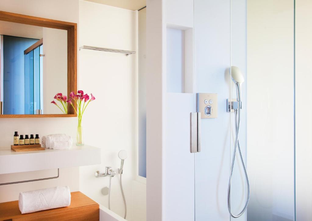 a bathroom with a shower with a glass door at Hotel Arima & Spa - Small Luxury Hotels in Donostia-San Sebastián