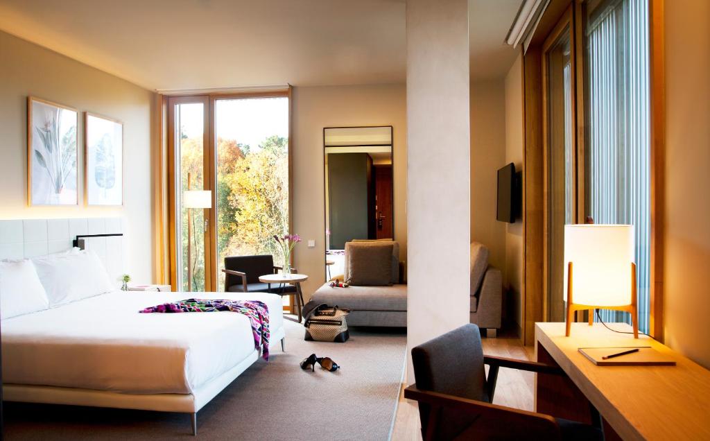 a hotel room with a bed and a cat in the room at Hotel Arima & Spa - Small Luxury Hotels in Donostia-San Sebastián