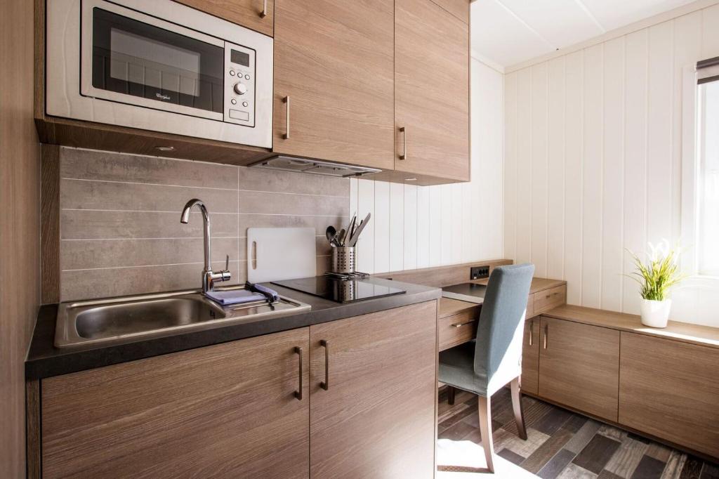 a kitchen with a sink and a microwave at Horten Apartment in Horten