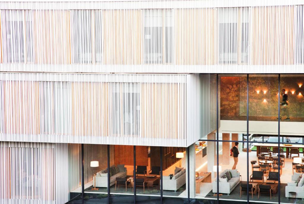 a view of a building with tables and chairs at Hotel Arima & Spa - Small Luxury Hotels in Donostia-San Sebastián