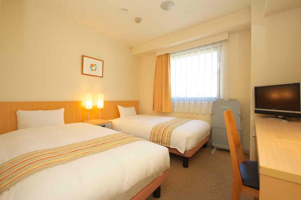 Un pat sau paturi într-o cameră la Chisun Hotel Hiroshima