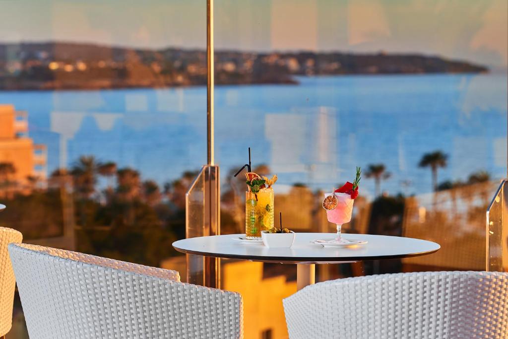 a table with two drinks on top of a balcony at Hipotels Playa de Palma Palace&Spa in Playa de Palma