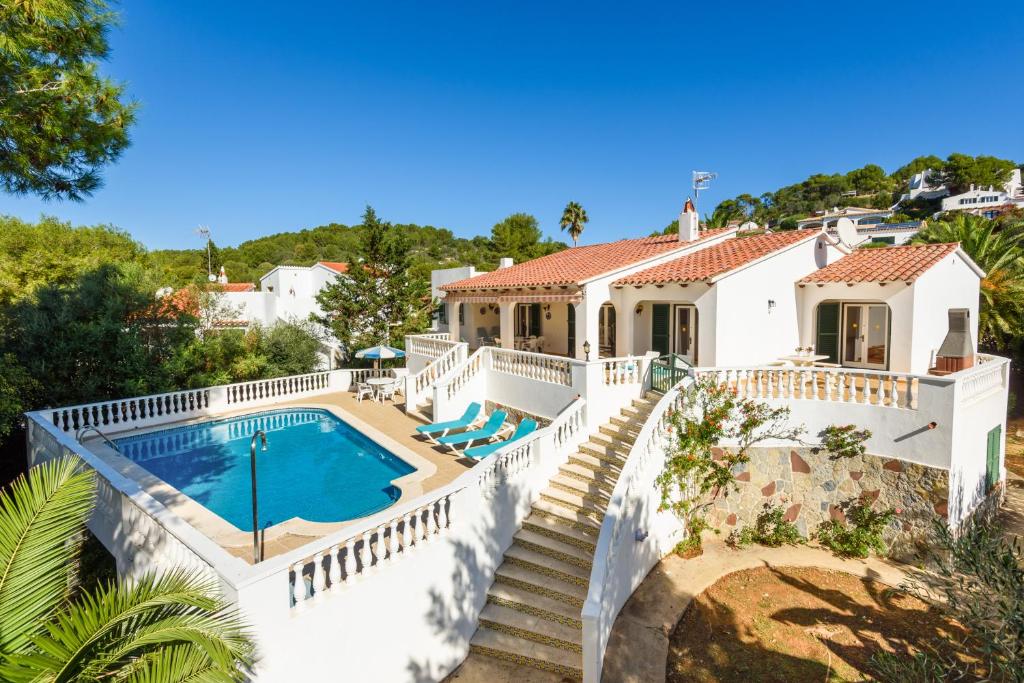 a large white house with a swimming pool at Villa Canela b11 in Santo Tomás