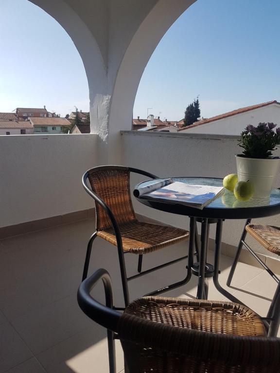 a table and chairs on a balcony with a table at Casa Nostra in Funtana