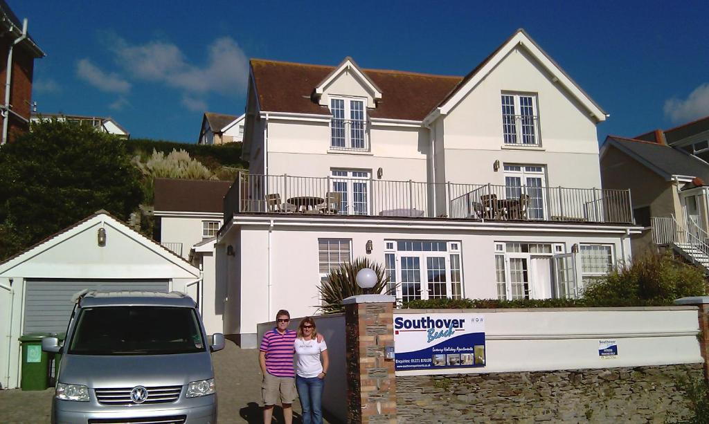 a family standing in front of a white house at Southover Beach in Woolacombe