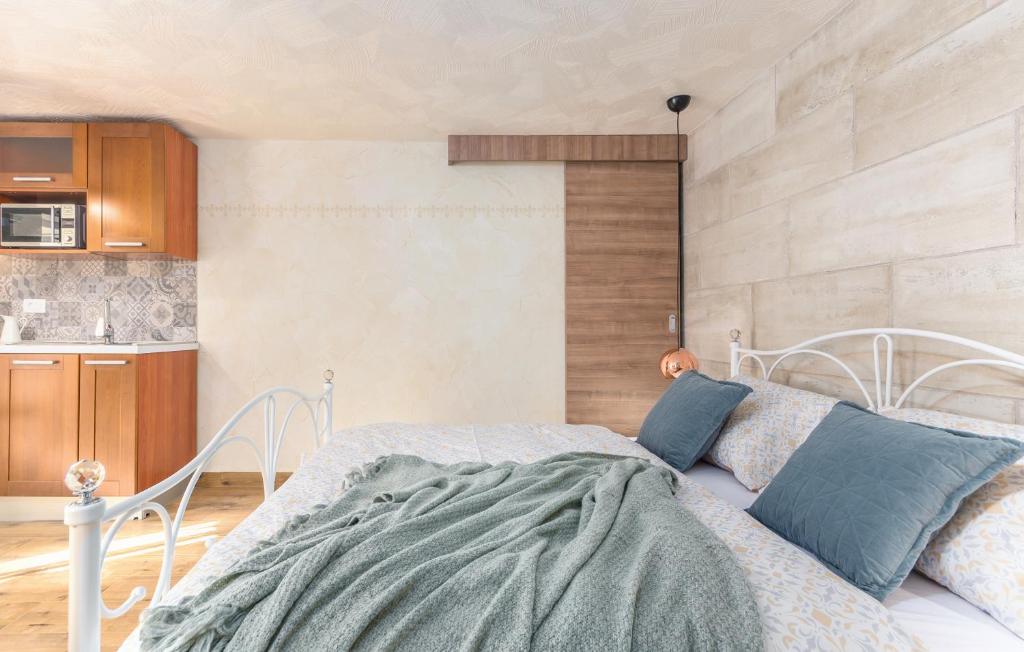 a bedroom with a white bed and a kitchen at Villa Stephany in Poreč