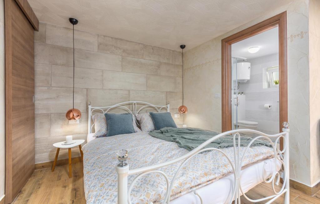 a bedroom with a white bed with blue pillows at Villa Stephany in Poreč