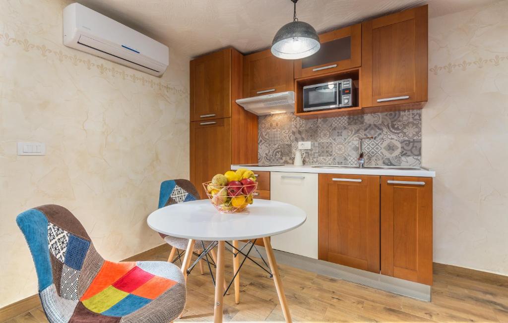 a kitchen with a table with a bowl of fruit on it at Villa Stephany in Poreč