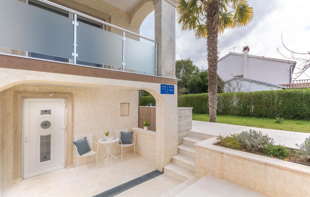 a glass house with two chairs and a table at Villa Stephany in Poreč