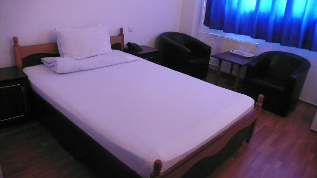 Postel nebo postele na pokoji v ubytování Hotel Uranus
