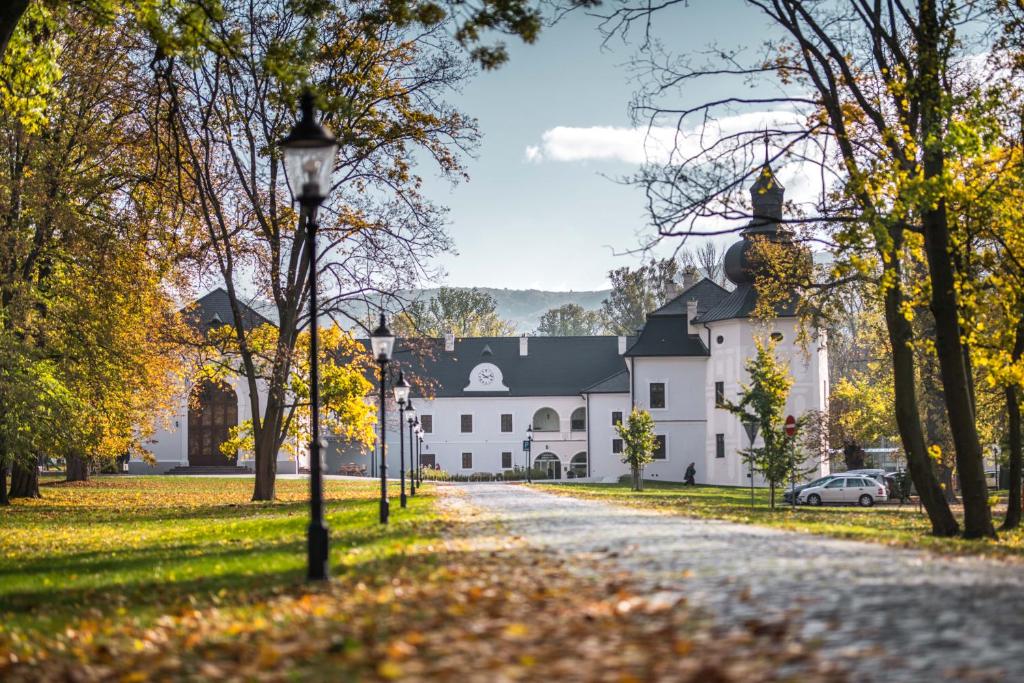 a large white building with a black roof at Chateau Appony in Oponice