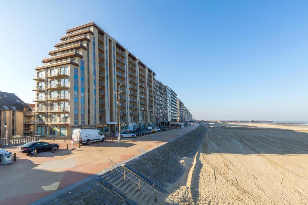 a view of a beach with a large building at Seaside Blankenberge in Blankenberge