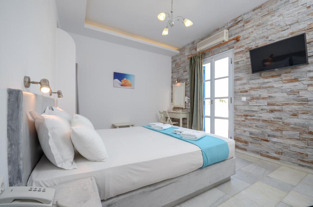 Postel nebo postele na pokoji v ubytování Dimitra Hotel