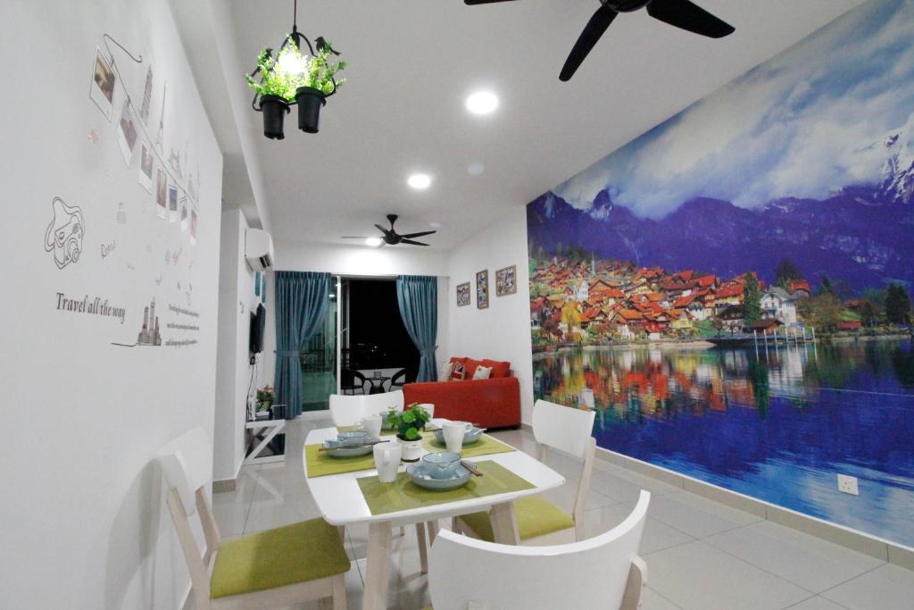 a dining room with a large painting on the wall at H2H - Swiss Home - Majestic Ipoh in Ipoh